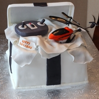 Remote Control Helicopter Helicopter and remote modeled from gumpaste/fondant. Giftbox is carrot cake filled with cream cheese and frosted in buttercream. Covered in...