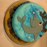 My Daughter's Dolphin Cake Painted the waves, with edible fondant rocks, seashells, and graham cracker sand.