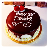 Ganache! Chocolate cake filled with bavarian cream and iced in buttercream and chocolate ganache. My writing on this cake is not very good but it&#...