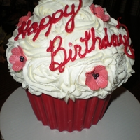 Giant Birthday Cupcake Giant cupcake, red velvet cake with cream cheese filling, shell was molded from colored chocolate, covered with buttercream icing, topped...