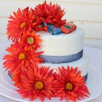 2 Tier Round Wedding Cake French Vanilla with raspberry jam in the center. Silk gerber daisey's