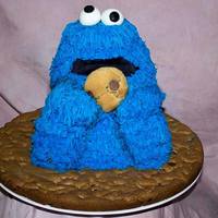 Cookie Monster Made for a friends daughter. Head and hands are Rice Krispy and body is cake sitting on a 16" round chocolate chip cookie base.