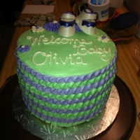 Baby Girl Shower Cake Petal techniques with gumpaste booties on top!