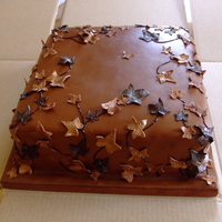 Single Tier Chocolate Wedding Cake 10 inch chocolate fudge cake with chocolate fudge/amerreto frosting, covered with belgian chocolate fondant. Choc fondant ivy leaves...