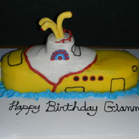 Yellow Submarine Yellow Submarine, only spouts and rudder are fondant. Cake is a sheet cake cut in a half and one cupcake for turret.
