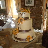 Sunflower Wedding Cake Top and bottom tier traditional west indian fruit cake ,middle tier vanilla with chocolate filling