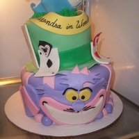 Alice In Wonderland Topsy Turvy Alexandra in wonderland topsy turvy cake, red velvet with vanilla buttercream, cheshire cat base/mad hatters hat in the middle with card...
