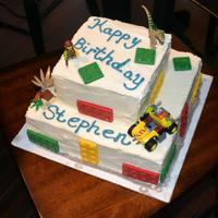 Lego Cake *Chocolate cake with white buttercream frosting with chocolate molded legos and real lego toy added.
