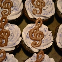 Birthday Cupcakes purple velvet cupcakes with Buttercream/creamcheese frosting topped with hand drawn chocolate treble clefs