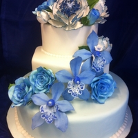 Blue Wedding Cake With Gumpaste Flowers This was my first attempt at gumpaste flowers on a cake. I tried to keep the cake simple so that the blue flowers would really pop. Any...