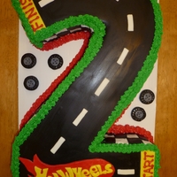 Number 2 Chocolate cake with buttercream icing. Black fondant pieces with Duff decorator's icing.