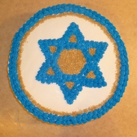 Star Of David White cake w/ white icing. Blue is BC decorator's icing. Gold sprinkles.