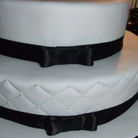 My Very First Wedding Cake I was soooo scared doing this! Choc mud/ dark choc ganache on the bottomBanana mud/ White choc ganache on the top.Royal icing dots on the...