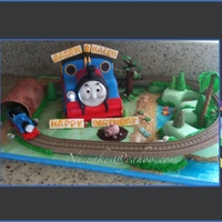 Thomas The Train I carved the train body. Gumpaste for Thomas face and tunnel. Number 3 for the island to represent the twin's age. Real toy small...