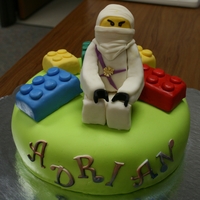 Ningago Lego Cake WASC cake with princess flavour butter cream, covered in fondant, with fondant covered rice krisipie treat figures and blocks, gum paste...