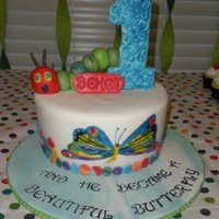 The Very Hungry Caterpillar Free-hand painted butterfly from Eric Carle's The Very Hungry Caterpillar atop this fondant covered cake. Caterpillar in fondant/...