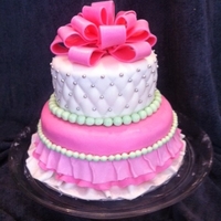 Pink Princess Ruffle Skirt Cake Pink Princess cake with quilting, edible silver pearls, and fondant skirt topped with a fondant/gumpaste bow.