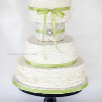 Ruffled Frill Wedding Cake I made fondant ruffles for the three tiers, and a paper mache dummy tier with a brooch and satin ribbon. This was for a wedding last...