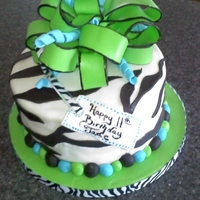 Green Zebra Cake Mint Chocolate Chip cake with fudge filling, fondant accents and bow.
