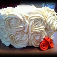 White Roses This is a vanilla bc white roses cake. Inside: chocolate with strawberry filling. Mini red roses are gumpaste.