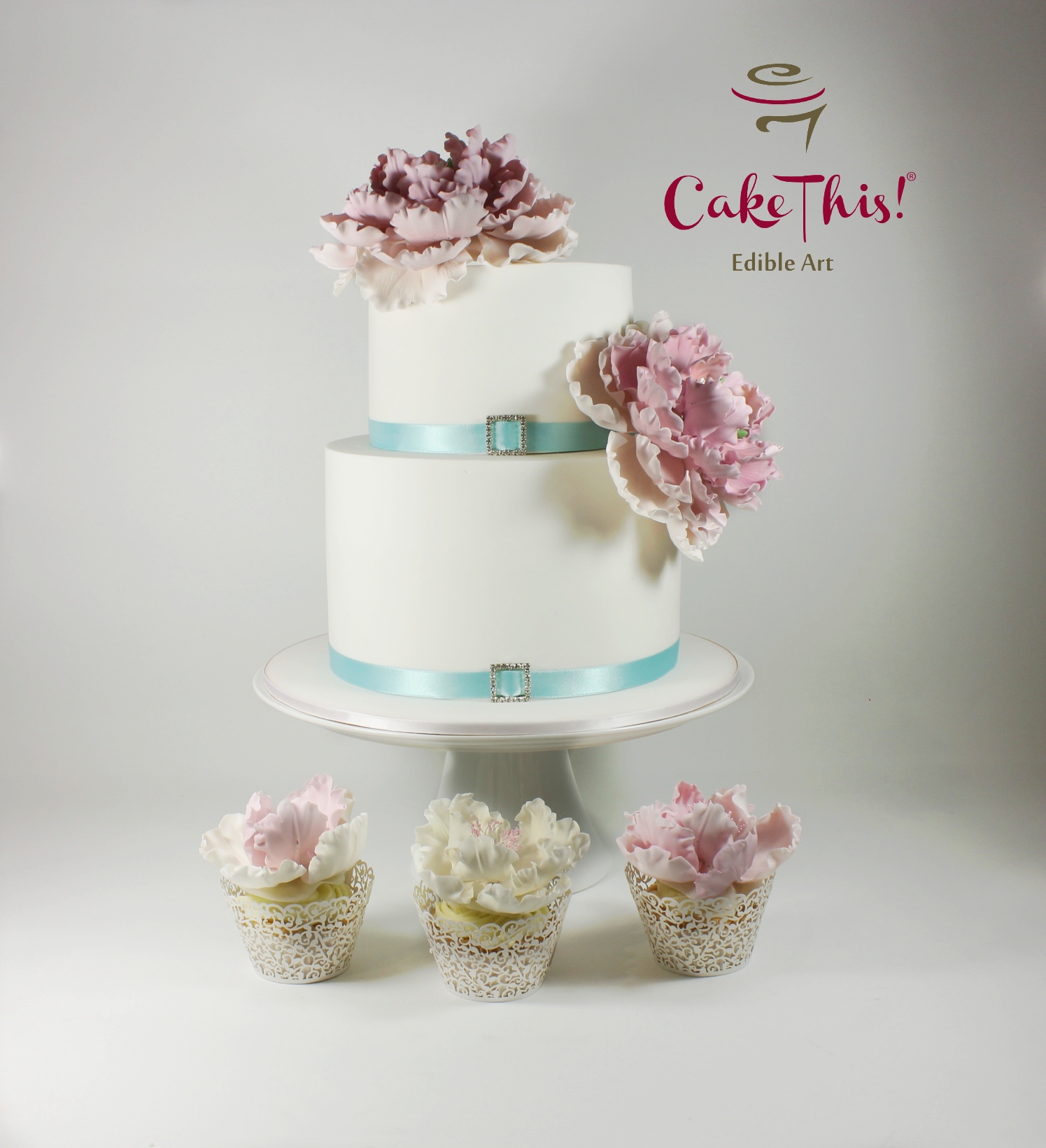 Pink Ombre Sugar Peony Wedding Cake Sugar peony wedding cake with matching cupcakes.