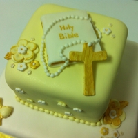 Christening Cake Pastel yellow, white, and gold accents.