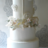 Wedding Cake With Cymbidium Orchids And Gardenias And Applications Inspired On Jackies Dress Wedding cake with cymbidium orchids and gardenia's, and applications inspired on Jackie's dress