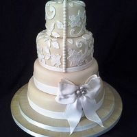 Champagne Coloured Fondant Decorated With Lace And A Gum Paste Bow Champagne coloured fondant decorated with lace and a gum paste bow.