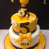 Two Tier Chocolate Cake With Rice Crispy Treat Bee And Fondant Embellishments Two tier chocolate cake with rice crispy treat bee and fondant embellishments.