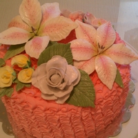 Gum Paste Flowers On A Pink Ruffled Cake 