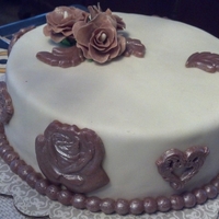 Chocolate Fondant Medallions And Roses This is my first cake with homemade chocolate fondant. I dusted everything with pearl dust and it changed the color to the look of copper...
