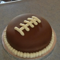 Fondant Football Cake I got bored and had an extra layer left over from the cake I did yesterday, so I made a fondant layer football cake. Because that's...