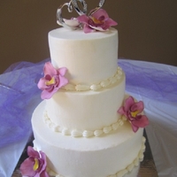 Buttercream Wedding Cake This was my first buttercream wedding cake. It was a pain, to say the least! I prefer fondant cakes anyday! I bought white sugar flowers...