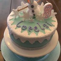 Lorelai's 8Th Birthday Olaf Birthday cake for my daughter. Olaf is made from gumpaste. The lace border is MMF. The cake is iced in light blue buttercream.