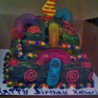 Slinky Cake! Two tier chocolate cake with Slinkies climbing down! Even inside of cake is rainbowed out!