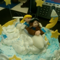 Glider In The Clouds Layered cake w buttercream clouds and fondant glider, people and stars