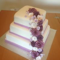 Purple Flower Cascade Cake This was my first wedding style cake for my husbands sister, was actually for her engagement party. All flowers are made from fondant