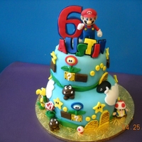 Super Mario Brothers Cake Super mario brothers theme for my son's 6th birthday. Everything is made out of fondant except the large mario.