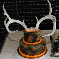 My Husband's Cake!! I made a 4-layer marble camo cake for my husband's groom's cake. The top tier is styrofoam. The antlers are real! HE LOVED IT!