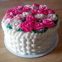 Basket Of Roses Vanilla bean cake with raspberry curd filling and American butter cream icing and roses.