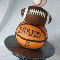 It's A Ball! Life size basketball, football and baseball cake.