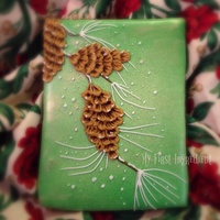 Seasons Greetings Cookie Sugar cookie royal iced and airbrushed. The pine cone is brushed embroidery royal icing