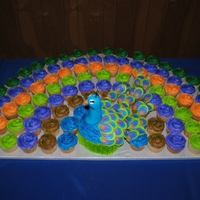 Peacock Cupcake/cake I made this Peacock themed cupcake cake for a rehearsal dinner. It was about 120 cucakes!