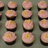 Olivia Cupcakes Carrot cake cupcakes, vanilla cupcakes, iced with decorators cream cheese icing. Hand made marshmallow fondant blossoms.