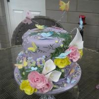 Butterflies & Flowers 60Th Birthday Cake Beatiful 2 tier Lemon Drizzle sponge cake. Covered in lilac fondant and decorated with handcrafted edible sugar butterflies, roses and...