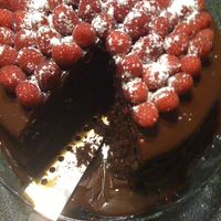 Raspberry Chocolate Ganache Cake FRESH RASPBERRIES, POWDERED SUGAR, CHOCOLATE GANACHE, CHOCOLATE CAKE