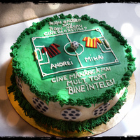 Buttercream Football! The writing says: Red black or red yellow who will win? Who will eat more cake of course!