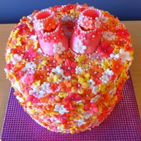 Baby Bootie Cake 8' 3 tier white cake. Orange curd and whipped cream filling and cream cheese frosting. Decorations made from fondant.