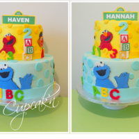 A Sesame Street Themed Birthday Cake With Fondant Cut Outs Displayed Are The Two Opposite Sides Of The Cake Celebrating The Birthday Of Twi... A Sesame Street themed birthday cake with fondant cut outs. Displayed are the two opposite sides of the cake celebrating the birthday of...