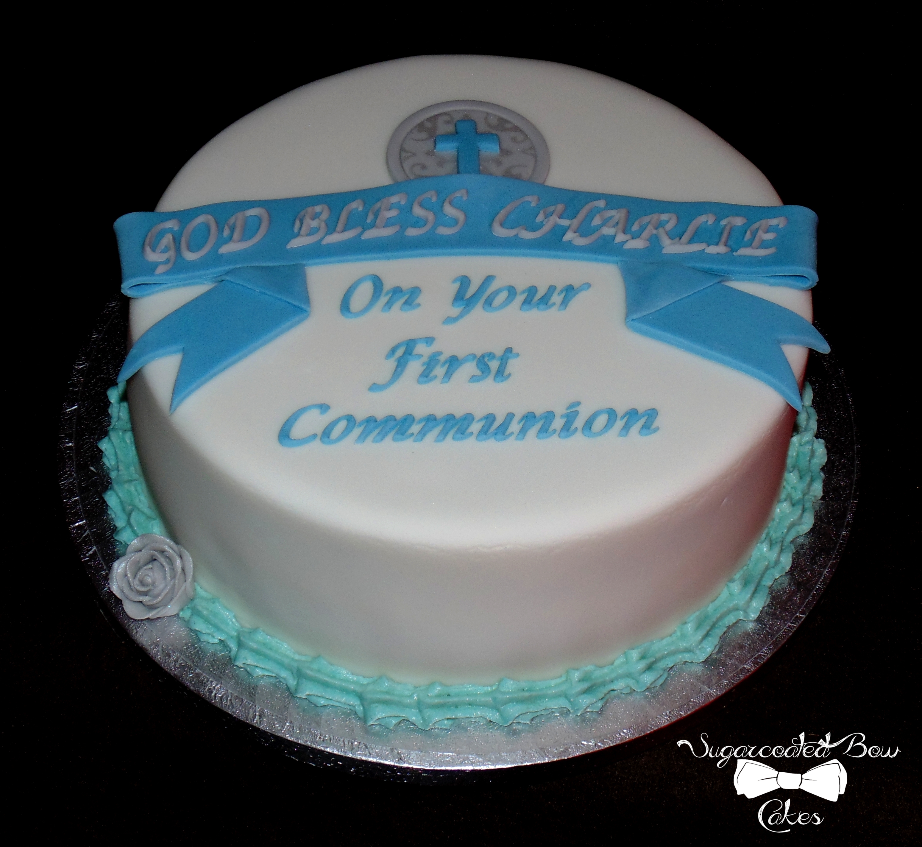 Communion Cake With Blue Banner And Simple Cross Detailing Communion Cake with blue banner and simple cross detailing.